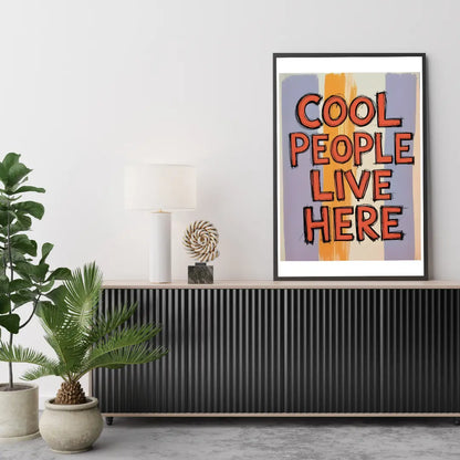 ForWalls.eu - Plakat Cool People Live Here - Framed poster with red and orange block letters reading "COOL PEOPLE LIVE HERE" on a blue and yellow abstract background. - classic, humor, plakat, well-being